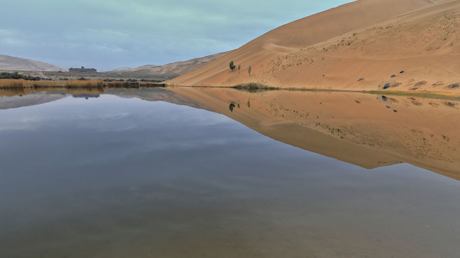 1032 lake badain east reflects a megadune of the badain jaran area-gobi desert. inner mongolia-china