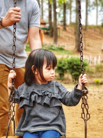 Full length of a girl on swing at playground