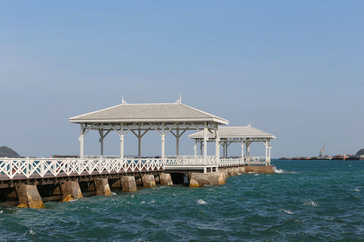 View of pier on sea against clear sky