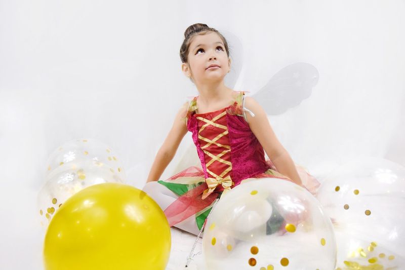 Cute girl looking at balloons
