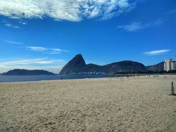 Scenic view of beach against blue sky