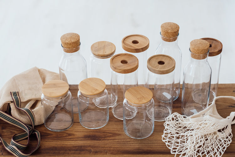 Zero waste concept. textile eco-bags and empty glass jars on a wooden table.