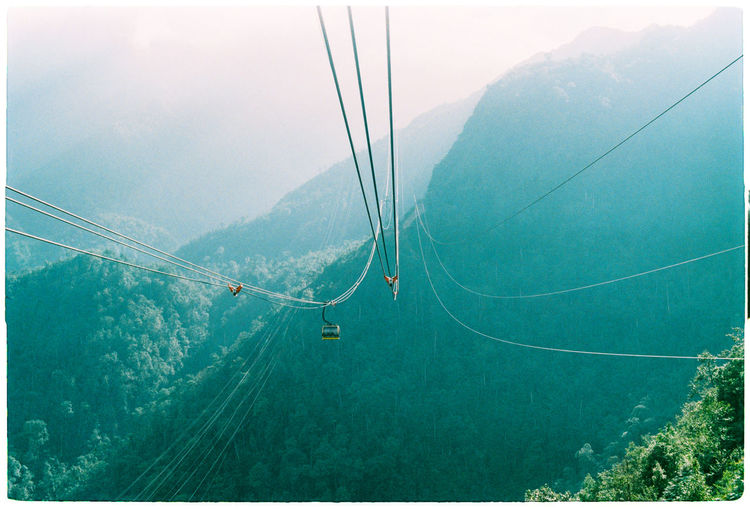 High angle view of overhead cable car against mountains