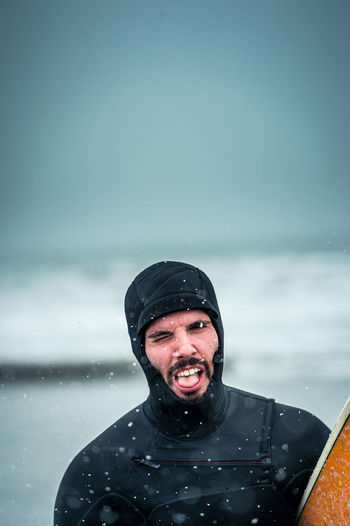 Man making a face after surfing during a nor'easter storm in maine