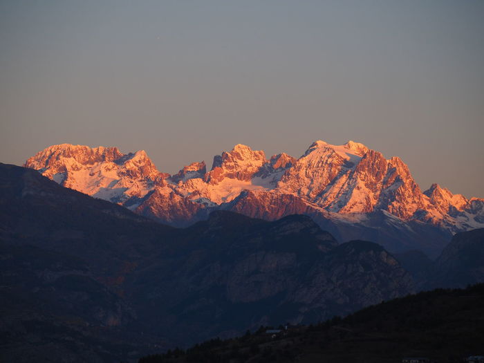 Scenic view of snowcapped mountains against sky during sunset