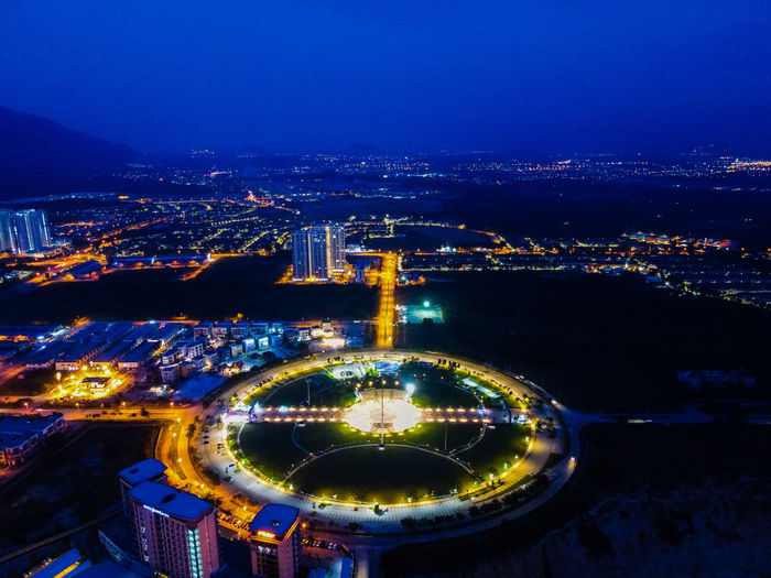 High angle view of illuminated city buildings at night