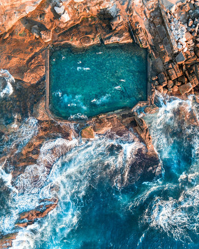 Aerial view of swimming pool in rock formation