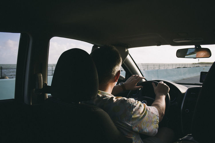 Rear view of man driving car