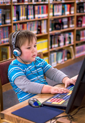 Boy using desktop computer at home