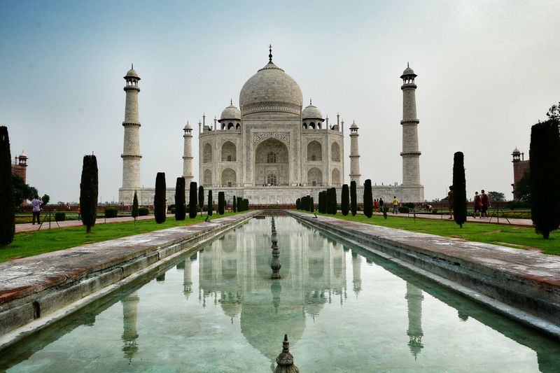 Reflecting pool against taj mahal in city