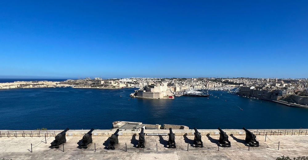 High angle view of townscape by sea against clear blue sky, saluting battery in malta