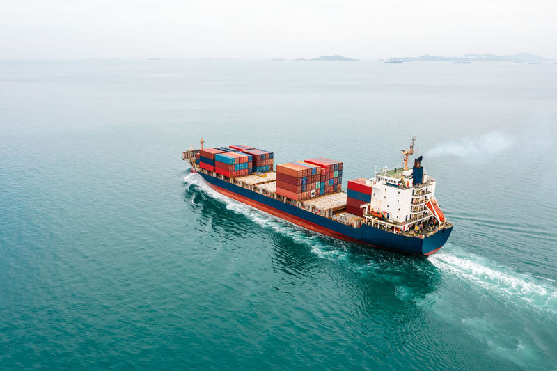 Container ship full speed sailing in sea for transporting cargo logistic import and export