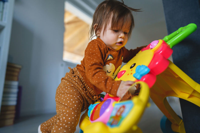 Portrait of cute girl playing with toy