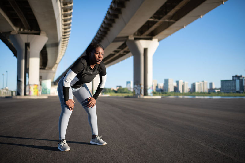 African american sportswoman resting during running training