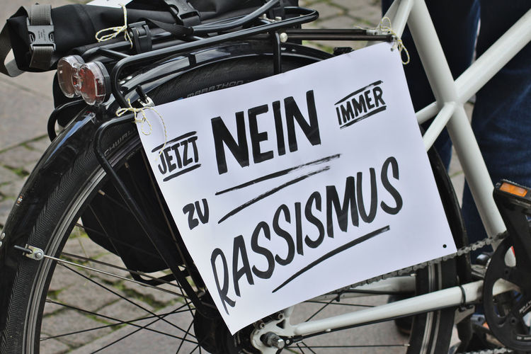 Close-up of bicycle with sign on street
