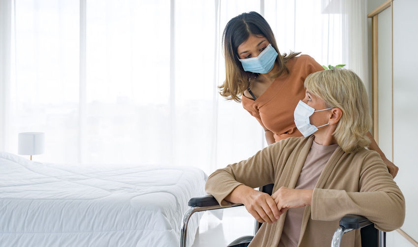 Daughter and mother wearing mask at hospital