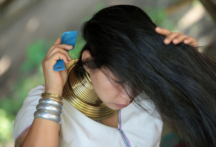 High angle view of woman combing hair