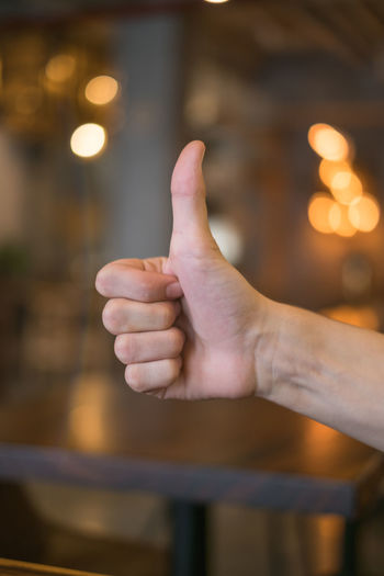 Close-up of hand showing thumbs up