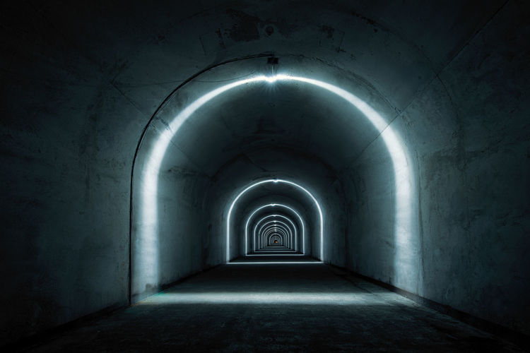 Diminishing perspective of illuminated tunnel