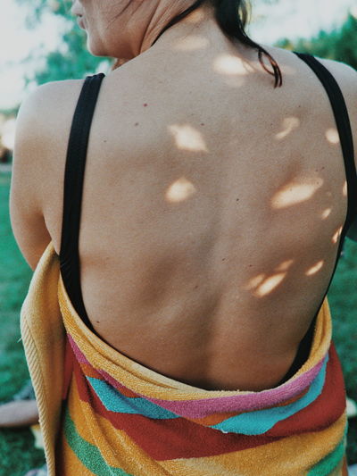 Midsection of shirtless woman