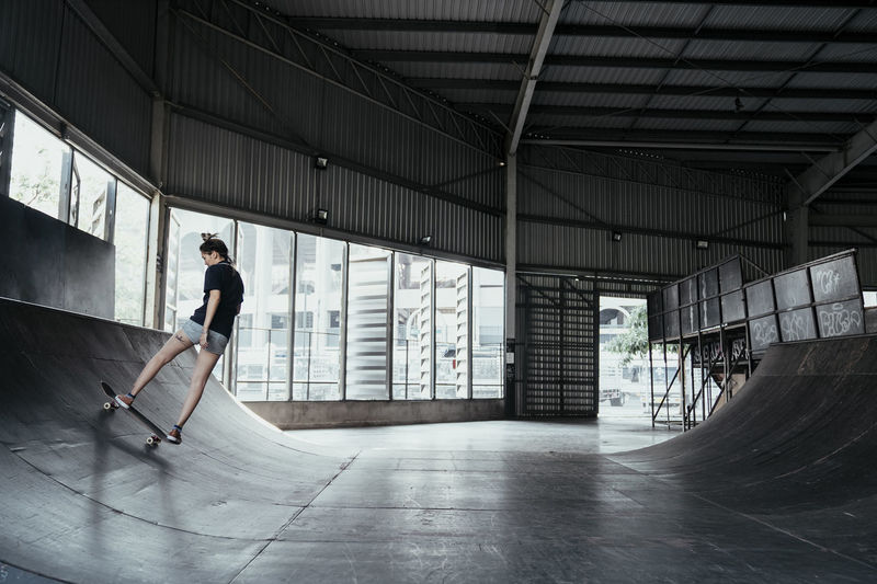 Full length of woman skateboarding on ramp