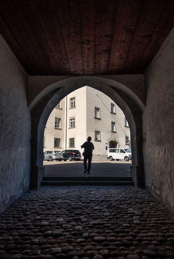 Rear view of woman walking in building