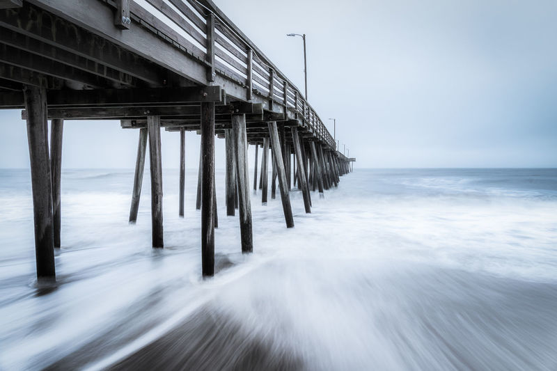 Pier over sea against sky