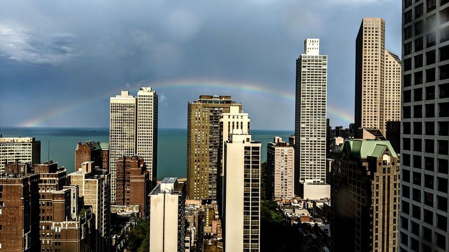 A rainbow appears over lake michigan as a storm passes over the gold coast area of downtown chicago