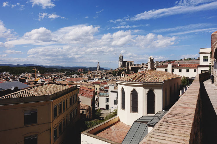 Buildings in town against sky