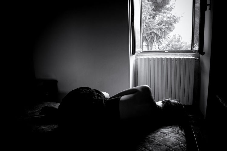 Rear view of woman resting at home
