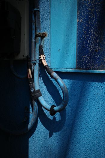 View of blue pipe against door