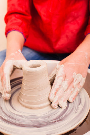 Midsection of woman working with clay