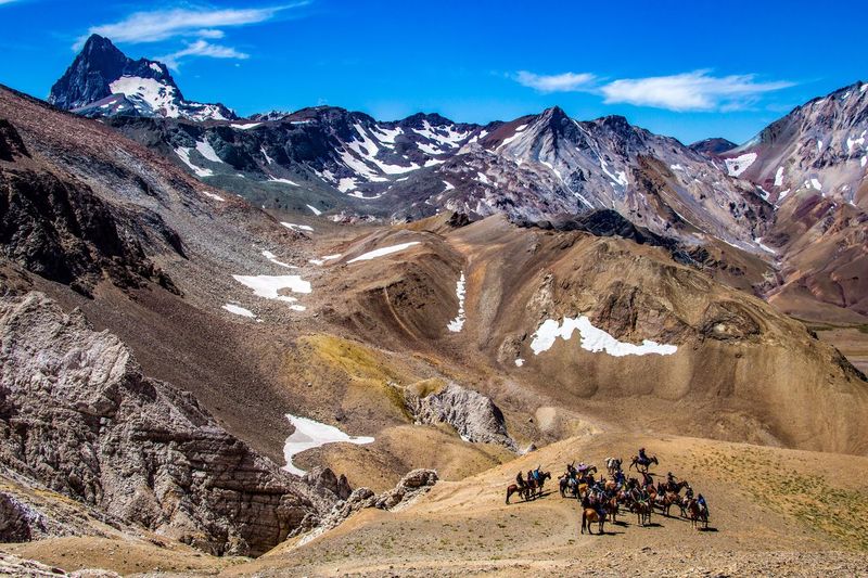 High angle view of people with horses on mountain