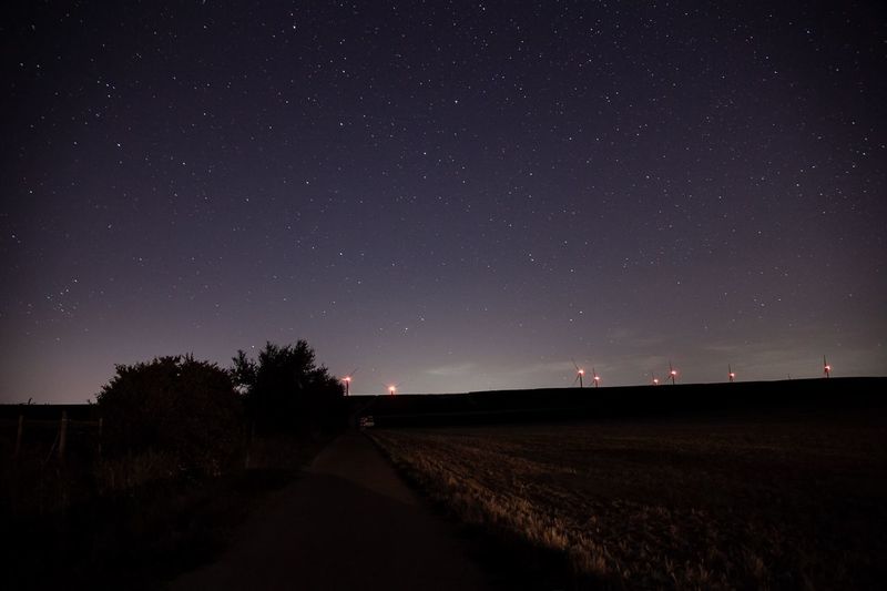 Scenic view of field against sky at night