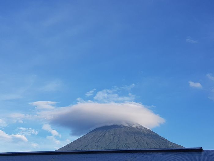 Volcanic mountain against blue sky