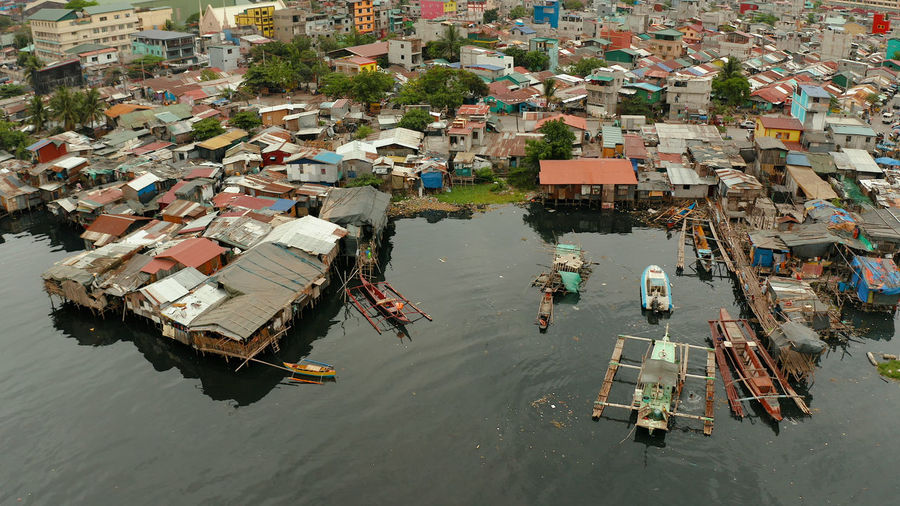 Slum area in manila, phillippines, top view. lot of garbage in the water.