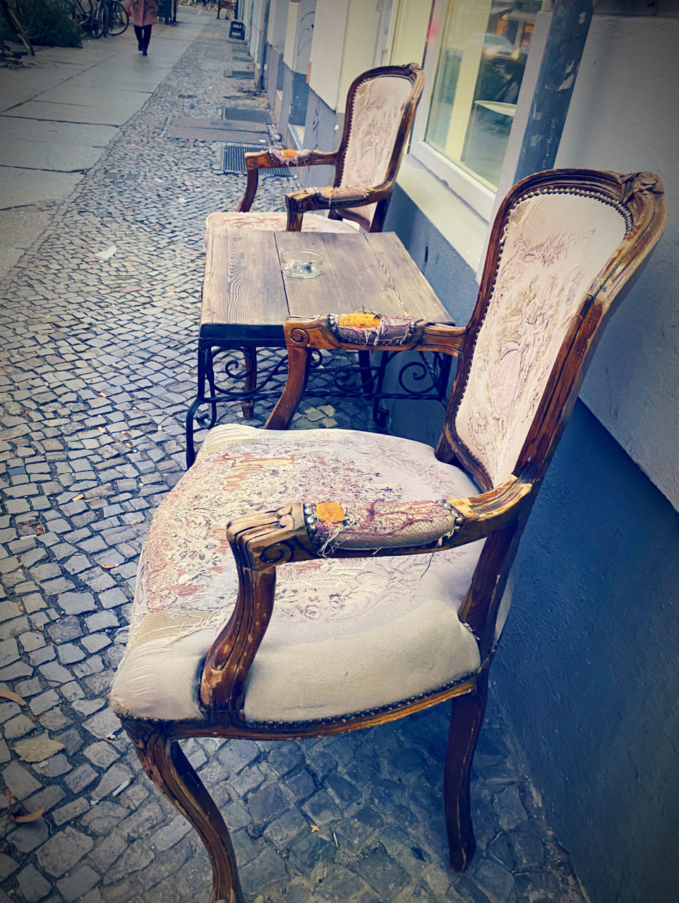 chair, seat, blue, furniture, no people, architecture, street, art, table, city, footpath, day, empty, absence, sidewalk, cobblestone, outdoors