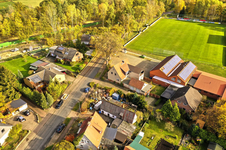 High angle view of houses and trees on field