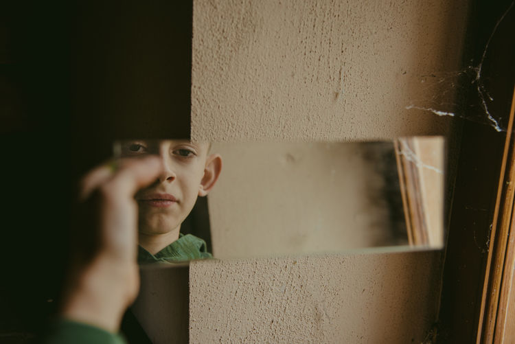 Closeup view of boy looking at the mirror