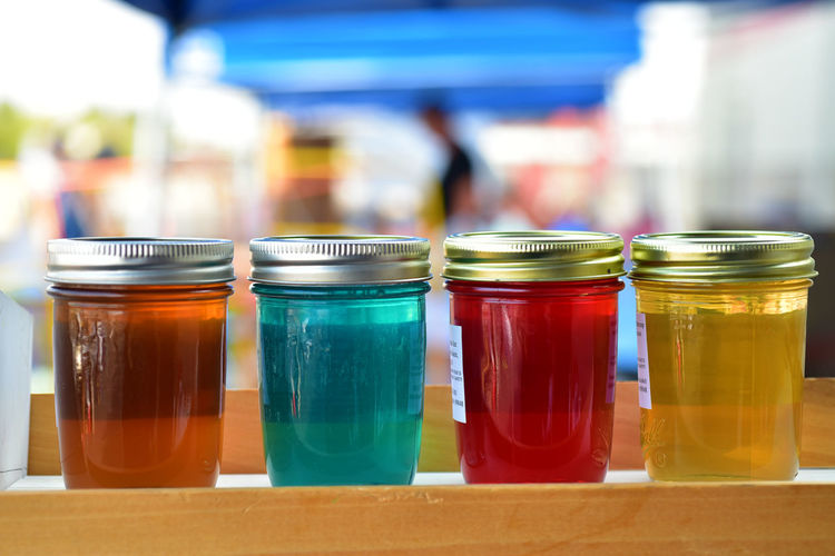 Row of colorful artisanal jelly in glass jars