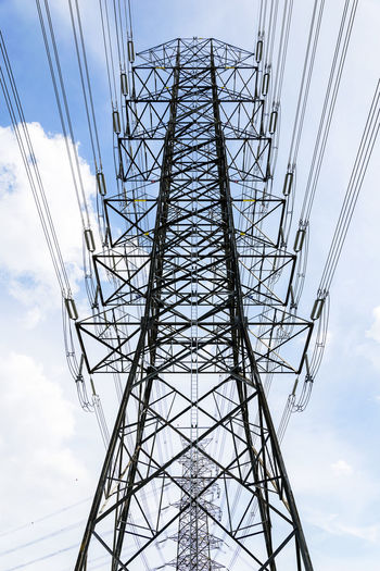 Low angle view of electricity pylon against sky