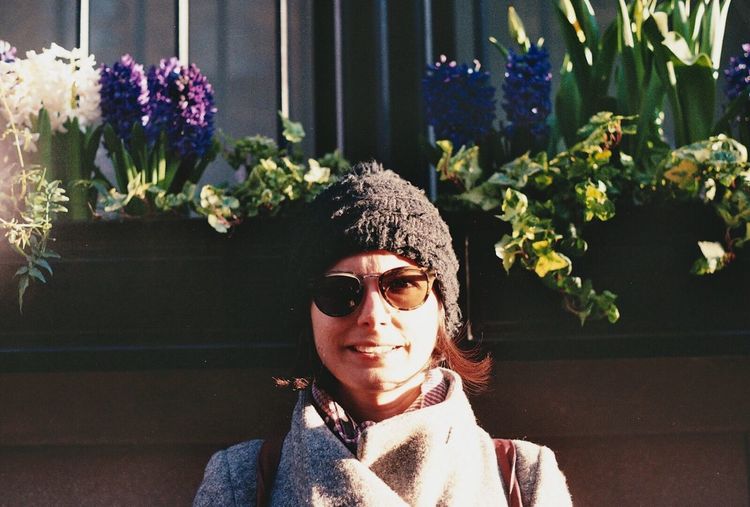 Portrait of young woman wearing sunglasses against plants