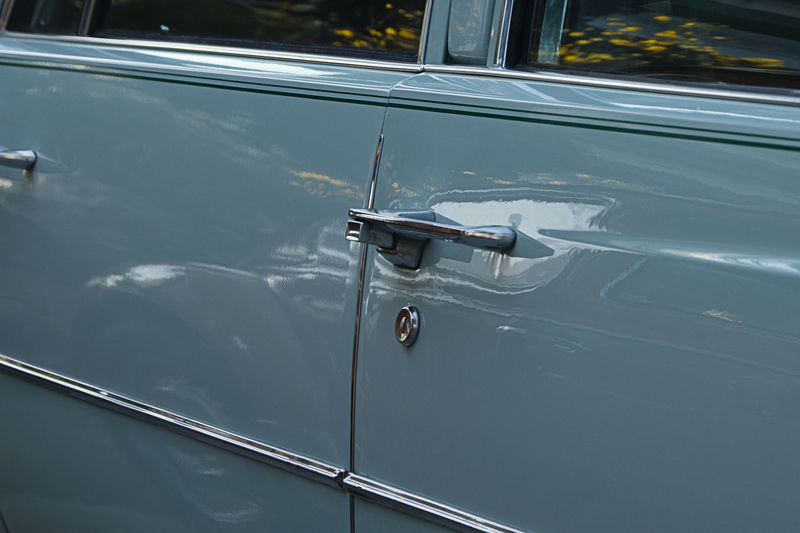 Cyan color antique car door detail. salvador bahia brazil.