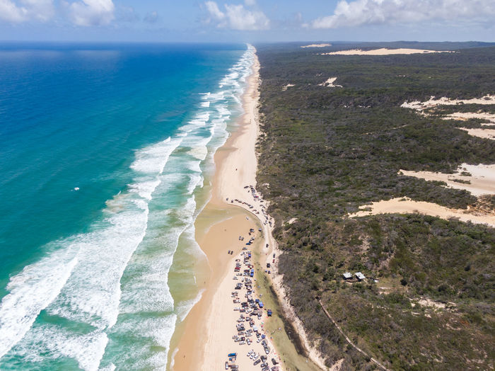 Aerial view of rock mountain by sea