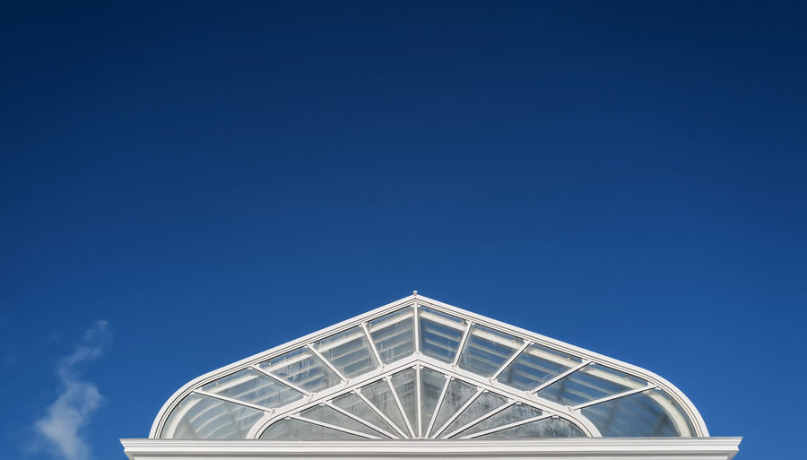 Low angle view of building against clear blue sky