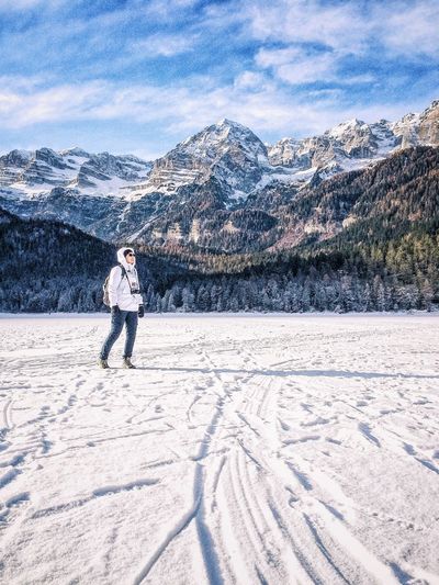 Woman standing on snow covered mountain