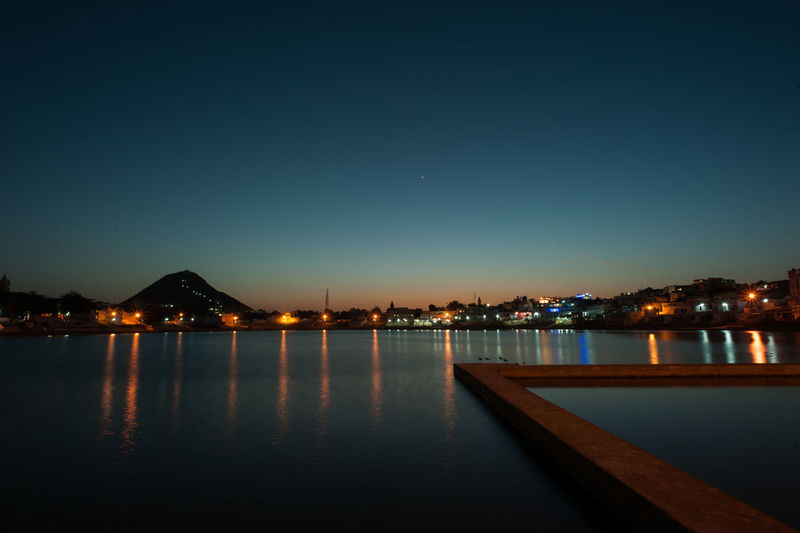 Illuminated city at waterfront