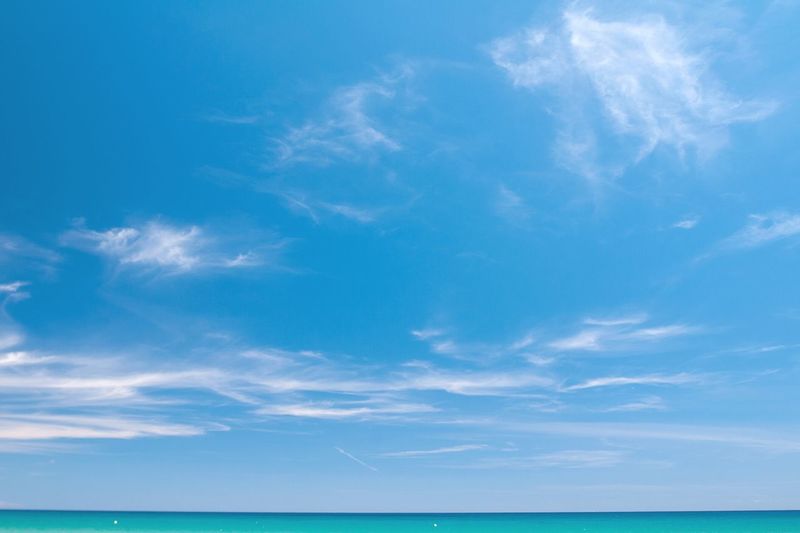 Low angle view of sea against blue sky