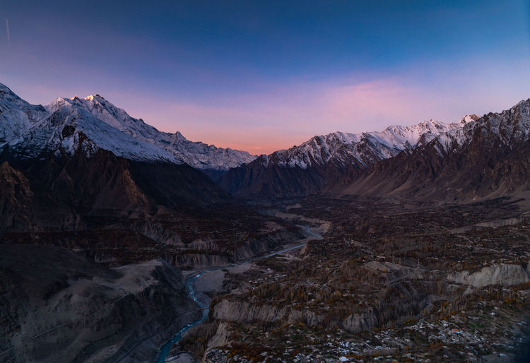 Scenic view of snowcapped mountains against sky during sunrise