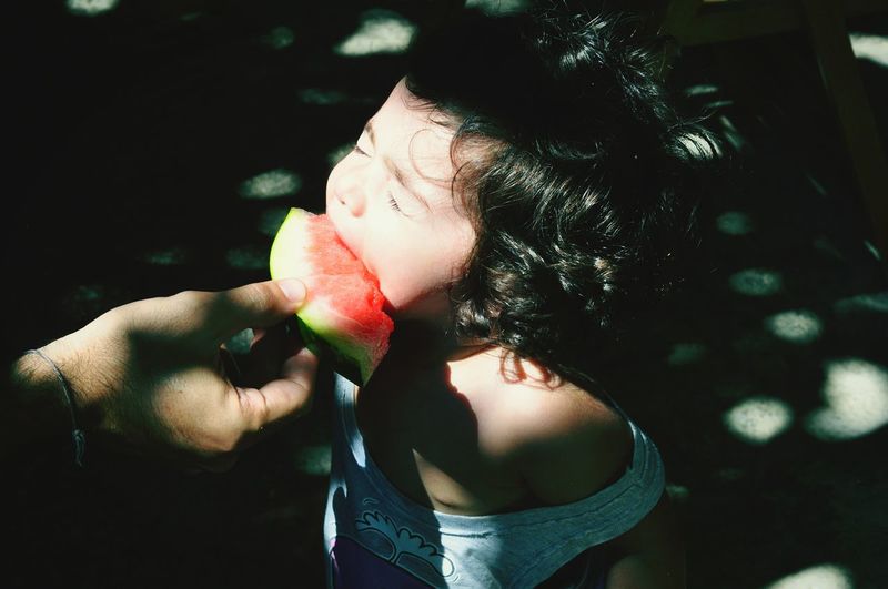 Close up of child eating watermelon